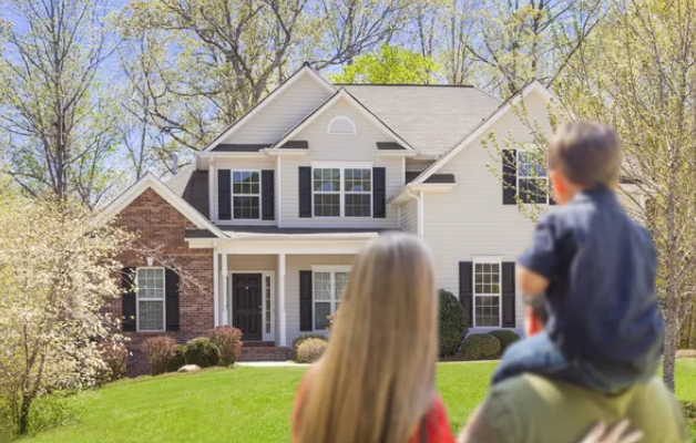 Home Family Looking Out Towards Their Dream Home